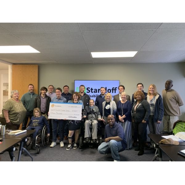 Imagine of Susan Menhard and the Fall 2019 Capstone Course being presented with a check.
