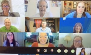 Screenshot of a virtual meeting. 9 people appear in equal rectangular boundaries. They are all smiling for a photo.
