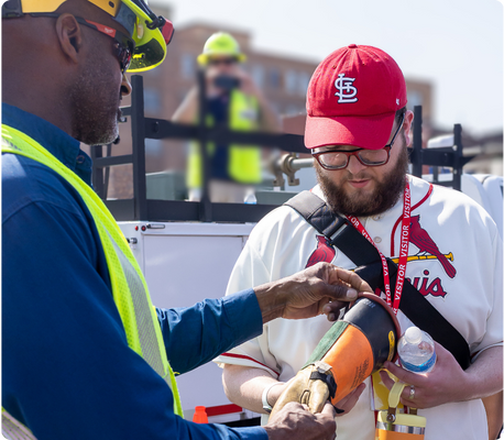 2025-camp-report-ameren-glove A student looks at the wheel of a small plane with an instructor.