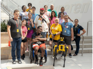Group photo of students and staff at Ameren, including a robot dog.