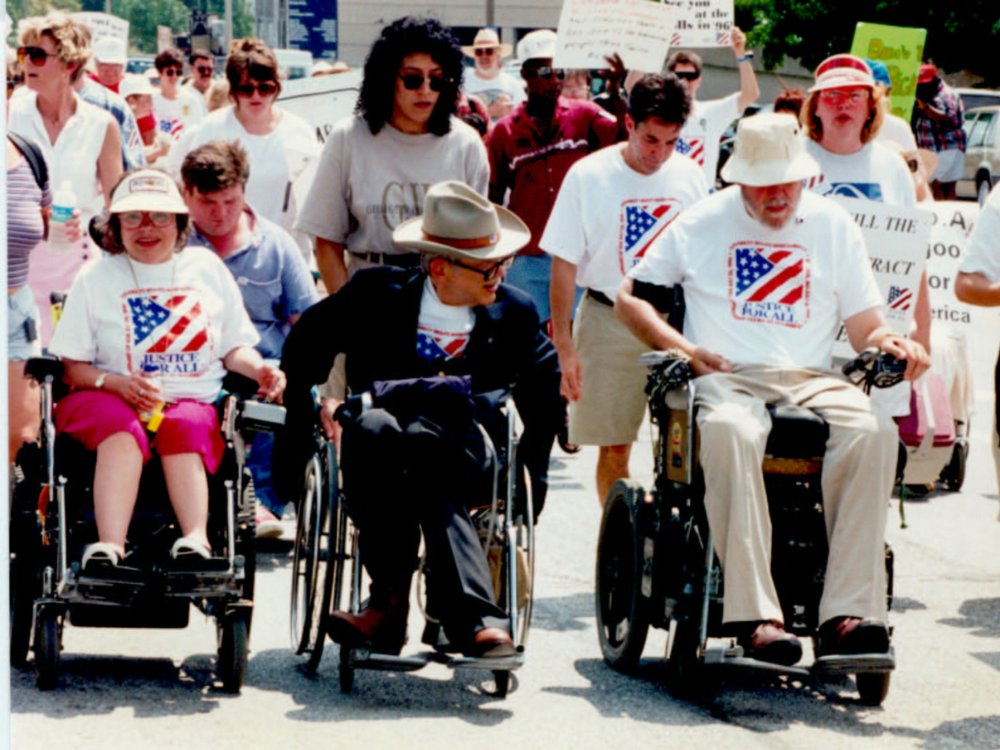 Leading a march through St. Louis streets: Judy Heumann, Justin and Yoshiko Dart, and Max Starkloff.