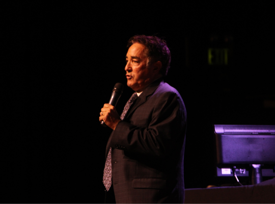 Ray Hartmann emceeing the first party to the Max onstage at the Pageant.