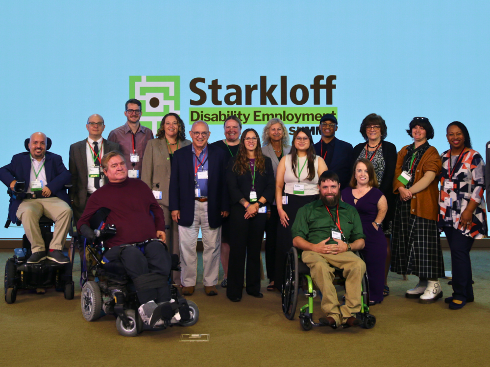 Starkloff Board and staff with Rebecca Cokely smiling as a group on the Employment Summit mainstage.