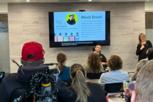 Drew Davis speaking in a conference room.