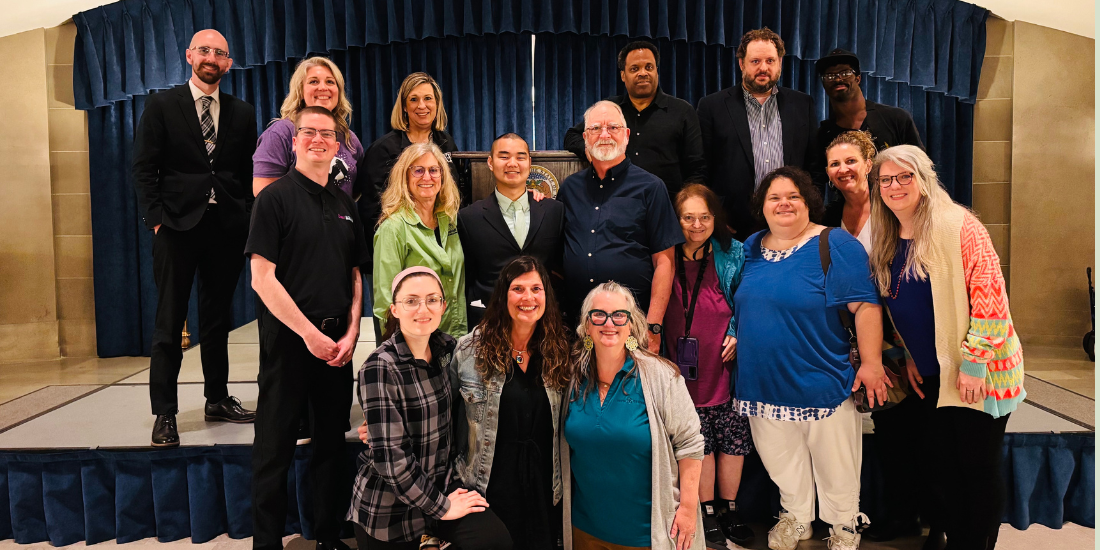 A group of nearly 20 people smiling together in the Missouri capital.
