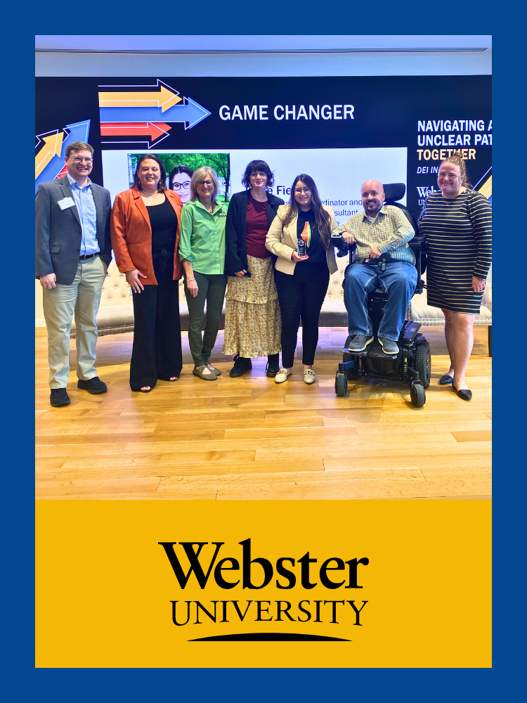 7 people smile together on stage at Webster University, some of whom have obvious disabilities.