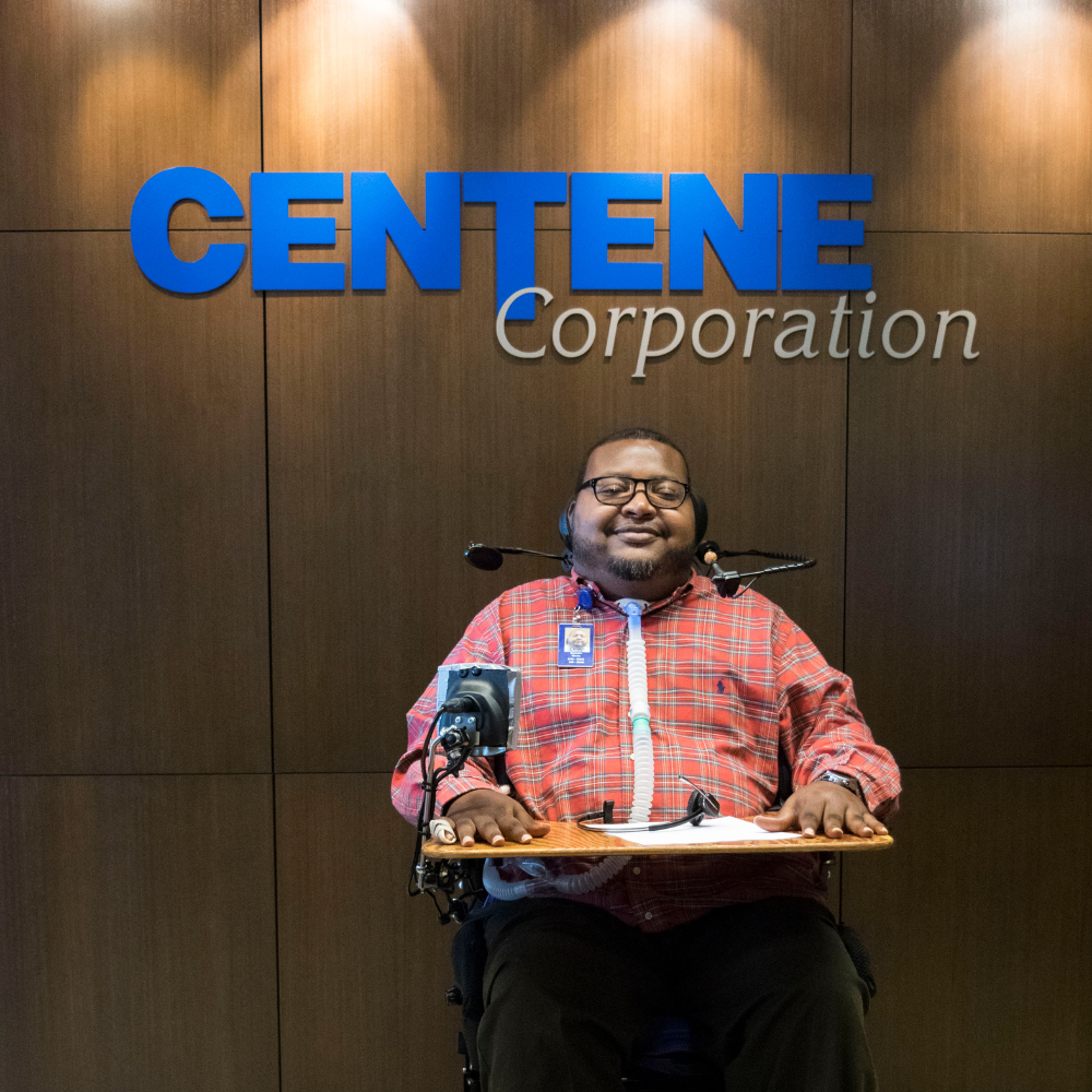 Brandon Morris Centene employee at work with his power chair and ventilator.